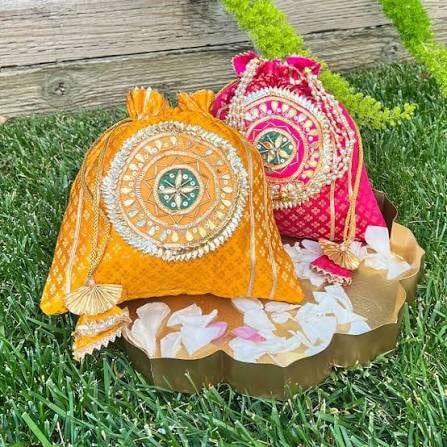 Hand-embroidered silk potli bags from Gujarat — set of 2 in complementary colours